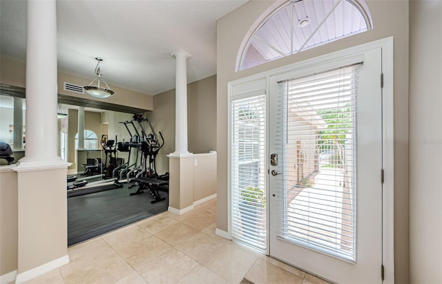 1710 Lago Vista Blvd, Palm Harbor, FL 34685 - foyer featuring decorative columns and light tile patterned flooring