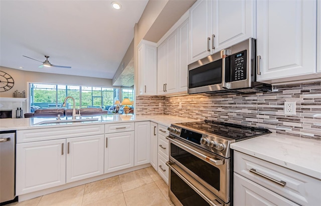 1710 Lago Vista Blvd, Palm Harbor, FL 34685 - kitchen with appliances with stainless steel finishes, a ceiling fan, backsplash, light tile patterned flooring, and recessed lighting