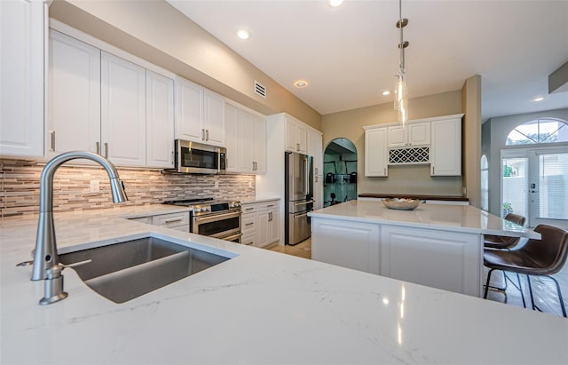 1710 Lago Vista Blvd, Palm Harbor, FL 34685 - kitchen featuring stainless steel appliances, decorative backsplash, light stone counters, and recessed lighting