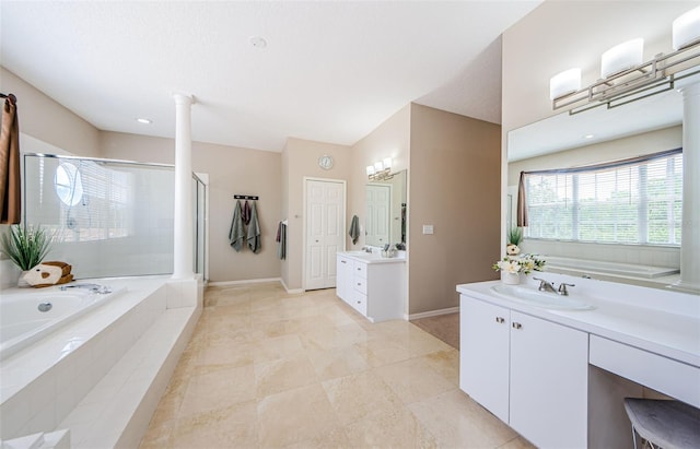 1710 Lago Vista Blvd, Palm Harbor, FL 34685 - bathroom with two vanities, a shower stall, a bath, and ornate columns