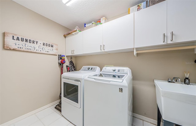 1710 Lago Vista Blvd, Palm Harbor, FL 34685 - laundry room featuring cabinet space, washing machine and dryer, and light tile patterned flooring