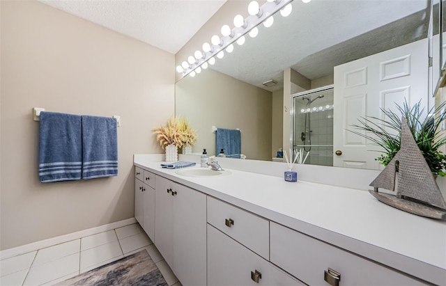 1710 Lago Vista Blvd, Palm Harbor, FL 34685 - bathroom with vanity, a shower stall, tile patterned flooring, and a textured ceiling