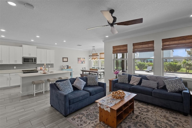 4077 Cadence Loop, Land O Lakes, FL 34638 - living area featuring crown molding, a ceiling fan, a textured ceiling, recessed lighting, and wood finish floors