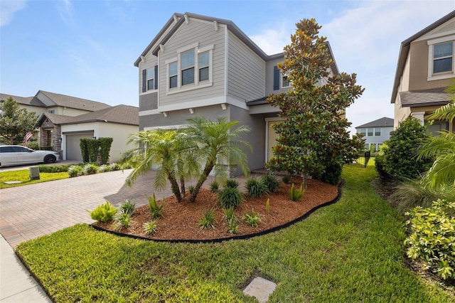 4077 Cadence Loop, Land O Lakes, FL 34638 - view of front of property featuring decorative driveway, stucco siding, and a front yard