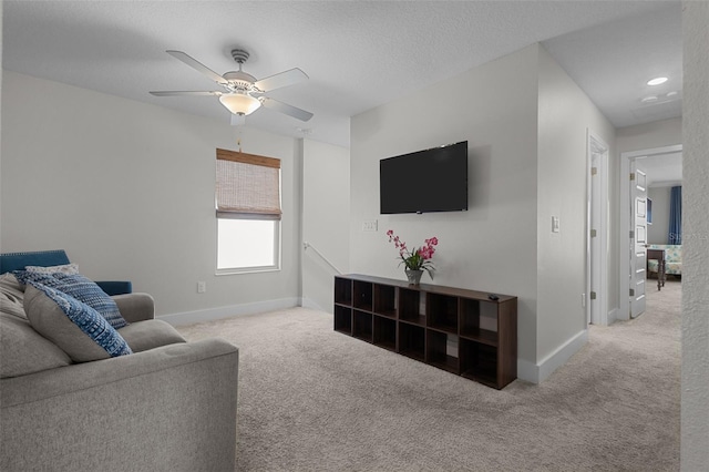 4077 Cadence Loop, Land O Lakes, FL 34638 - living area featuring carpet, baseboards, and a ceiling fan