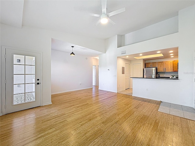 2015 SE 10th Ave Unit 123, Fort Lauderdale, FL 33316 - unfurnished living room with light wood-style floors, a ceiling fan, a towering ceiling, and recessed lighting