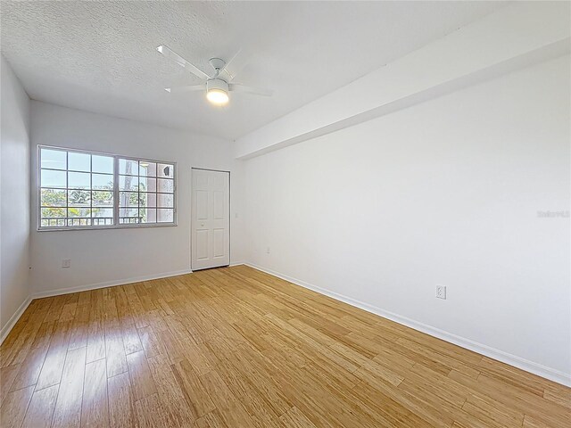 2015 SE 10th Ave Unit 123, Fort Lauderdale, FL 33316 - empty room featuring light wood-type flooring, ceiling fan, and a textured ceiling