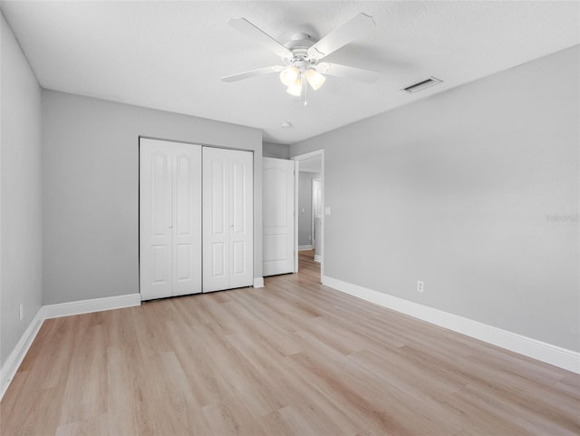 8806 Bayaud Dr, Tampa, FL 33626 - unfurnished bedroom with a closet, light wood-style flooring, baseboards, and a ceiling fan