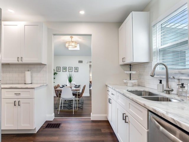 1243 55th Ave N, Saint Petersburg, FL 33703 - kitchen with stainless steel dishwasher, decorative backsplash, white cabinets, dark wood-style flooring, and recessed lighting