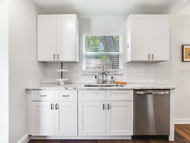 1243 55th Ave N, Saint Petersburg, FL 33703 - kitchen with stainless steel dishwasher, backsplash, light stone countertops, and white cabinetry