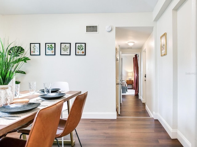 1243 55th Ave N, Saint Petersburg, FL 33703 - dining space with dark wood-style floors and baseboards