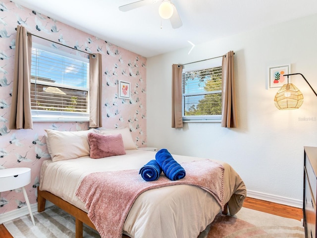 1243 55th Ave N, Saint Petersburg, FL 33703 - bedroom with wood finished floors, multiple windows, and a ceiling fan