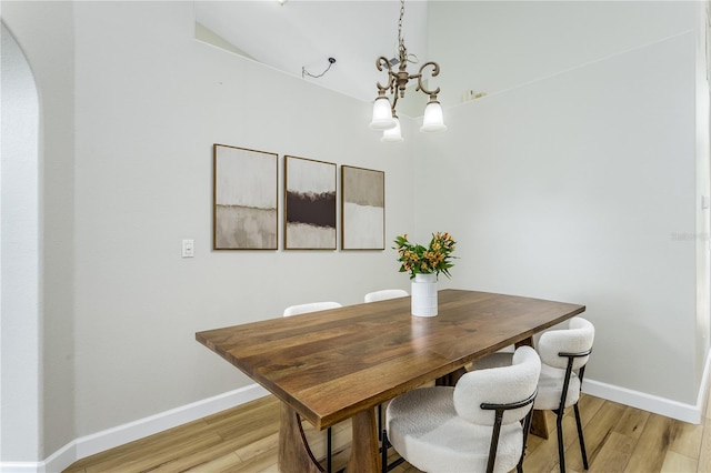 12335 Glenfield Ave, Tampa, FL 33626 - dining area featuring light wood finished floors, baseboards, and arched walkways