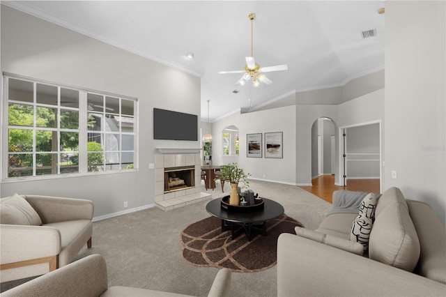12209 Glencliff Cir, Tampa, FL 33626 - carpeted living room with arched walkways, ornamental molding, ceiling fan, a fireplace, and high vaulted ceiling