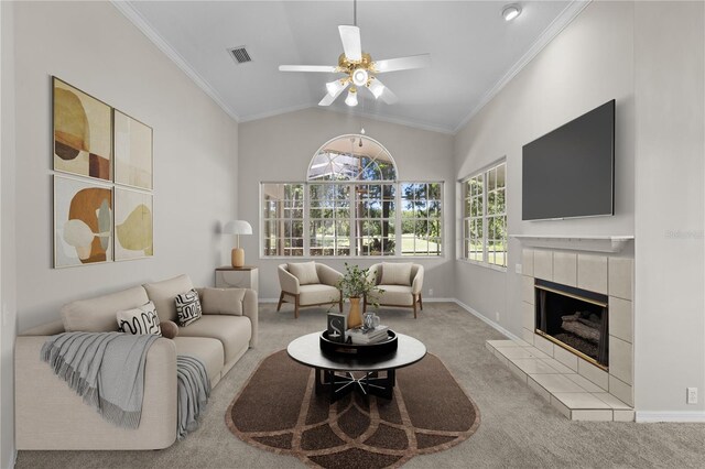12209 Glencliff Cir, Tampa, FL 33626 - living room with carpet flooring, a ceiling fan, crown molding, a tile fireplace, and lofted ceiling