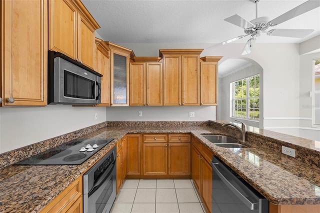 12209 Glencliff Cir, Tampa, FL 33626 - kitchen featuring stainless steel appliances, dark stone countertops, light tile patterned floors, a ceiling fan, and glass insert cabinets