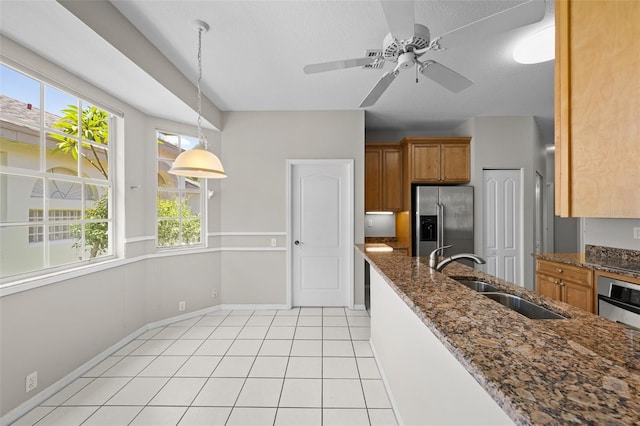 12209 Glencliff Cir, Tampa, FL 33626 - kitchen with stainless steel fridge with ice dispenser, brown cabinetry, dark stone countertops, and pendant lighting