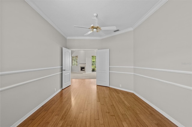 12209 Glencliff Cir, Tampa, FL 33626 - unfurnished room featuring light wood finished floors, ceiling fan, and crown molding