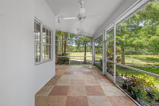 12209 Glencliff Cir, Tampa, FL 33626 - unfurnished sunroom featuring a ceiling fan, vaulted ceiling, and view of wooded area