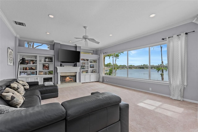 15012 Maurine Cove Ln, Odessa, FL 33556 - living area featuring crown molding, a ceiling fan, light colored carpet, recessed lighting, and a tiled fireplace