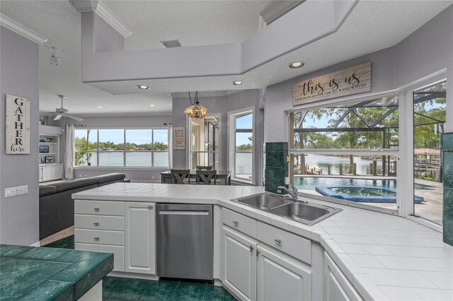 15012 Maurine Cove Ln, Odessa, FL 33556 - kitchen featuring stainless steel dishwasher, tile counters, open floor plan, white cabinetry, and recessed lighting