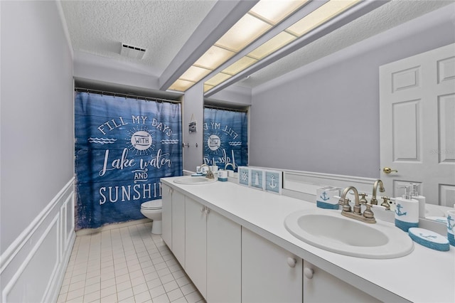 15012 Maurine Cove Ln, Odessa, FL 33556 - full bathroom featuring a textured ceiling, double vanity, and tile patterned flooring