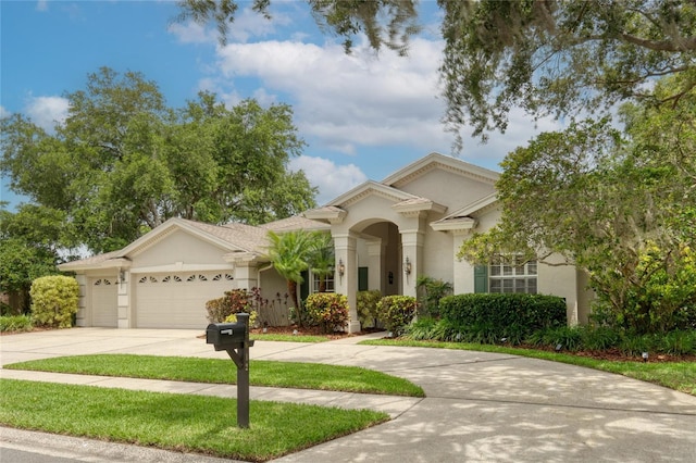 15012 Maurine Cove Ln, Odessa, FL 33556 - view of front of property with driveway, a garage, and stucco siding
