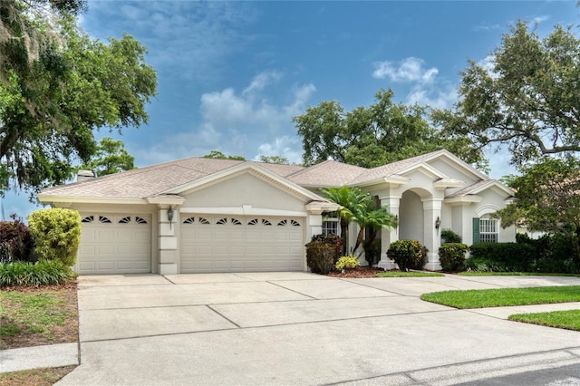 15012 Maurine Cove Ln, Odessa, FL 33556 - ranch-style home featuring an attached garage, driveway, and stucco siding