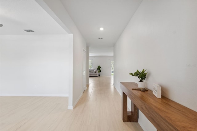 34797 Rainville Loop, Zephyrhills, FL 33541 - corridor featuring recessed lighting, baseboards, and light wood-style flooring