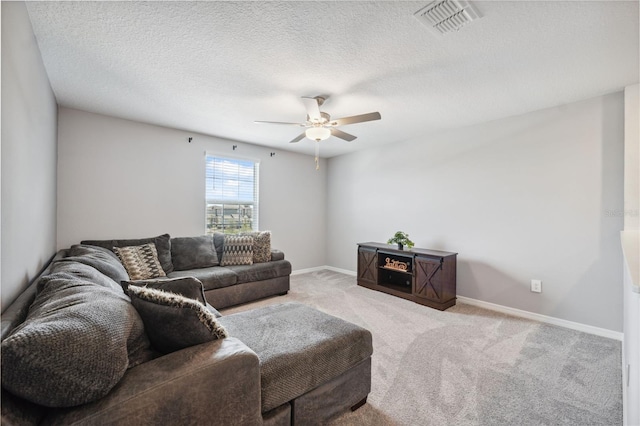 34797 Rainville Loop, Zephyrhills, FL 33541 - carpeted living area featuring ceiling fan, baseboards, and a textured ceiling