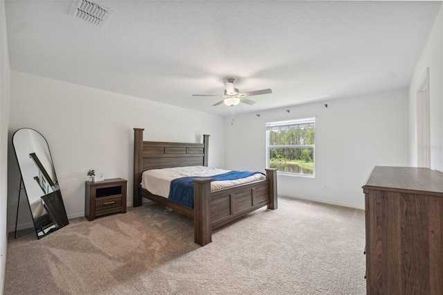 34797 Rainville Loop, Zephyrhills, FL 33541 - bedroom with light colored carpet, baseboards, and ceiling fan