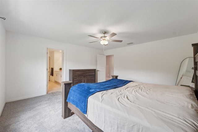 34797 Rainville Loop, Zephyrhills, FL 33541 - bedroom featuring light colored carpet, baseboards, ceiling fan, and connected bathroom