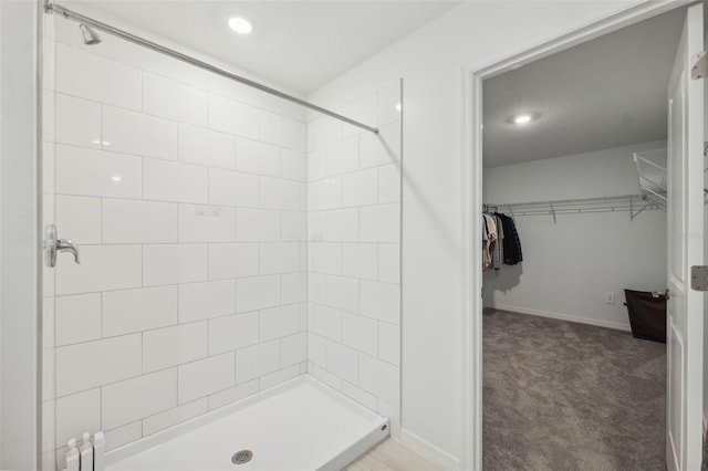 34797 Rainville Loop, Zephyrhills, FL 33541 - full bathroom featuring tiled shower, a walk in closet, baseboards, and recessed lighting