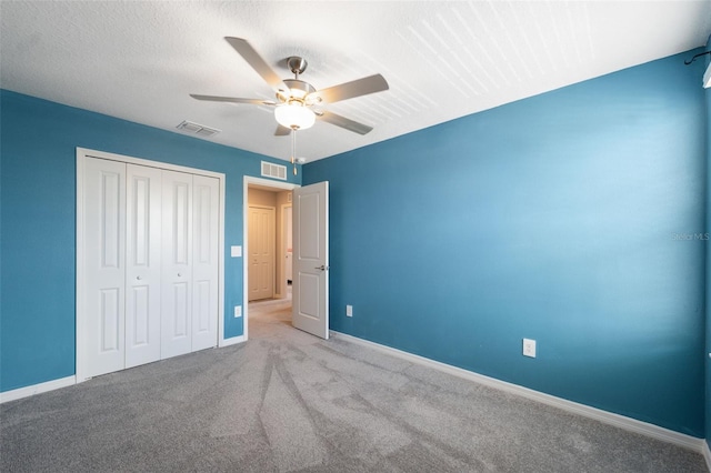 34797 Rainville Loop, Zephyrhills, FL 33541 - unfurnished bedroom featuring carpet floors, a closet, baseboards, and a ceiling fan