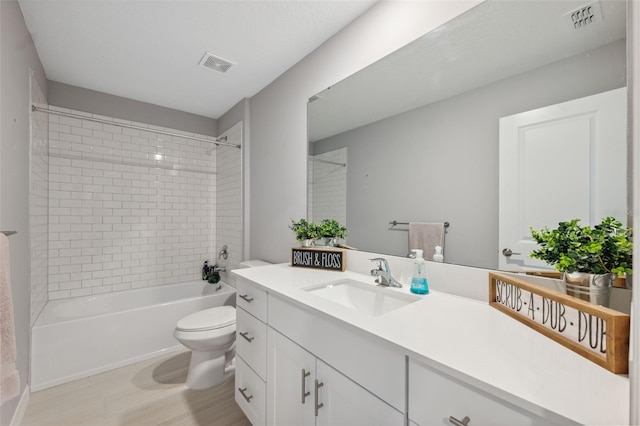 34797 Rainville Loop, Zephyrhills, FL 33541 - full bathroom featuring vanity, toilet, shower / bathtub combination, and wood finished floors