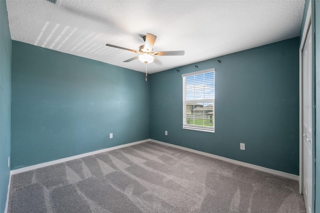 34797 Rainville Loop, Zephyrhills, FL 33541 - unfurnished room featuring carpet floors, a ceiling fan, baseboards, and a textured ceiling