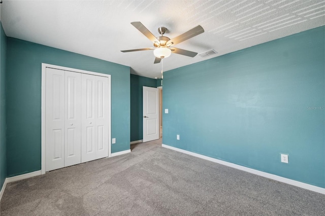 34797 Rainville Loop, Zephyrhills, FL 33541 - unfurnished bedroom with baseboards, carpet flooring, a closet, and a ceiling fan