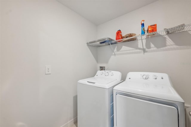 34797 Rainville Loop, Zephyrhills, FL 33541 - laundry area with separate washer and dryer and baseboards