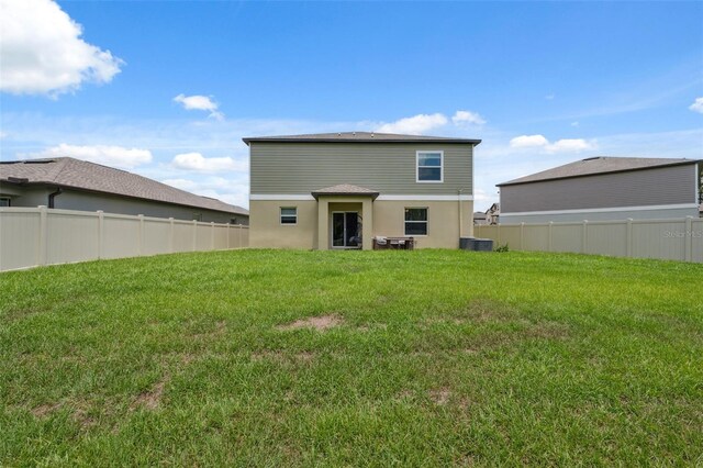 34797 Rainville Loop, Zephyrhills, FL 33541 - rear view of house featuring central air condition unit and stucco siding