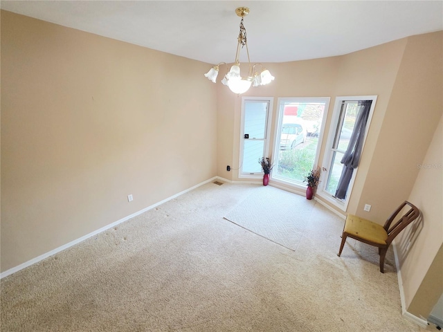 2975 E Withlacoochee Trl, Dunnellon, FL 34434 - spare room featuring light colored carpet and a chandelier