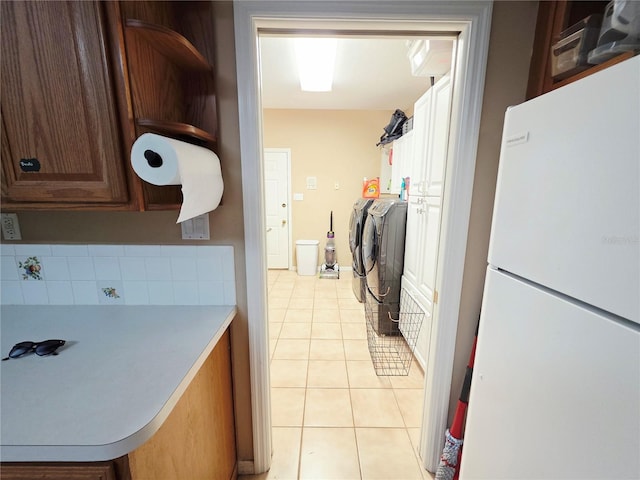 2975 E Withlacoochee Trl, Dunnellon, FL 34434 - washroom featuring independent washer and dryer, cabinet space, and light tile patterned floors