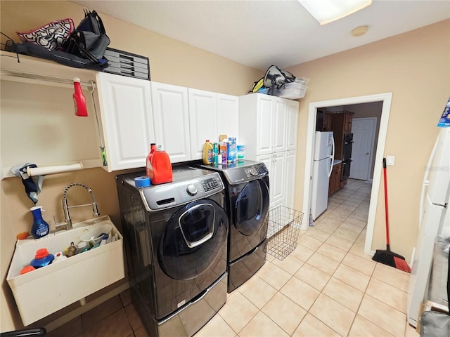 2975 E Withlacoochee Trl, Dunnellon, FL 34434 - laundry area featuring washing machine and clothes dryer, cabinet space, and light tile patterned flooring