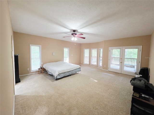 2975 E Withlacoochee Trl, Dunnellon, FL 34434 - bedroom featuring access to exterior, french doors, light colored carpet, and a ceiling fan