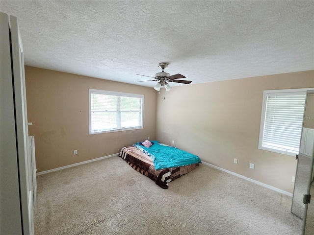 2975 E Withlacoochee Trl, Dunnellon, FL 34434 - carpeted bedroom with a textured ceiling and a ceiling fan