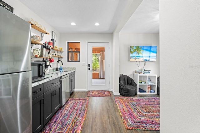 7013 W Polaris Ct, Homosassa, FL 34446 - kitchen featuring appliances with stainless steel finishes, open shelves, dark wood-style floors, recessed lighting, and light stone counters