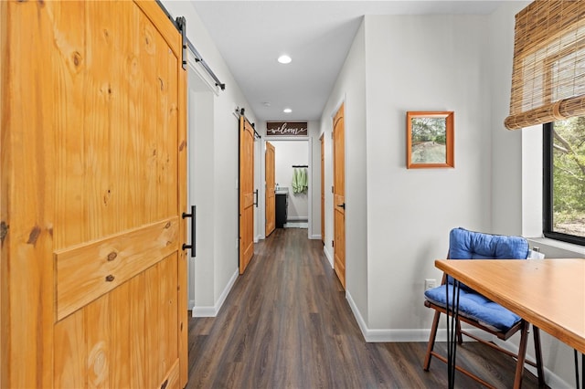 7013 W Polaris Ct, Homosassa, FL 34446 - hallway featuring a barn door, dark wood-type flooring, and recessed lighting