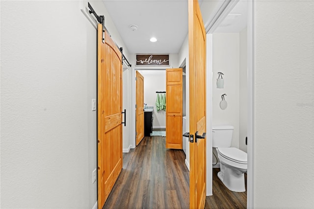 7013 W Polaris Ct, Homosassa, FL 34446 - hall with dark wood-style flooring, a barn door, and recessed lighting