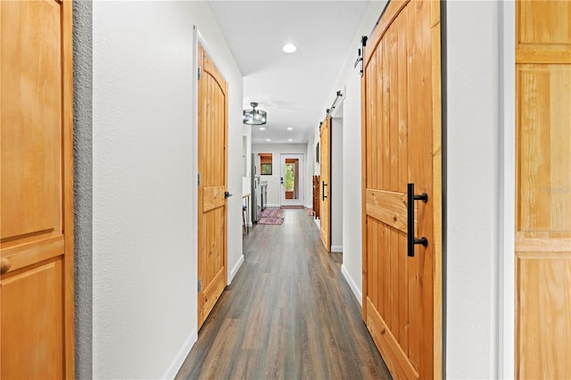 7013 W Polaris Ct, Homosassa, FL 34446 - hall featuring dark wood finished floors, a barn door, and recessed lighting