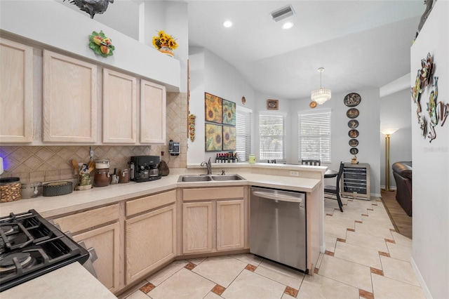 19104 Cellini Pl, Lutz, FL 33558 - kitchen with light brown cabinetry, a peninsula, backsplash, stainless steel dishwasher, and light countertops