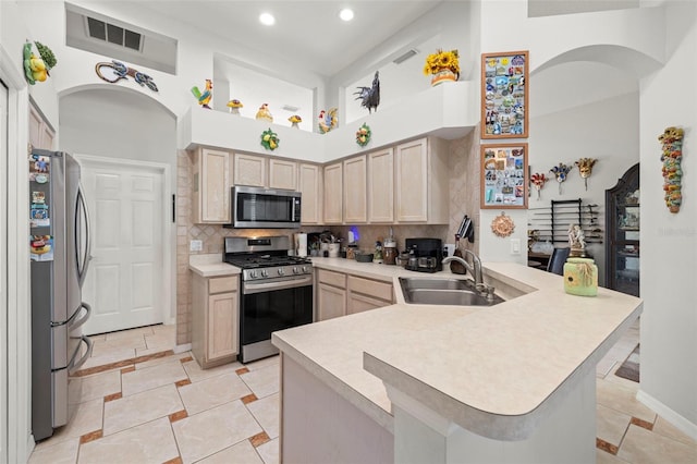 19104 Cellini Pl, Lutz, FL 33558 - kitchen with a peninsula, stainless steel appliances, a high ceiling, light countertops, and recessed lighting